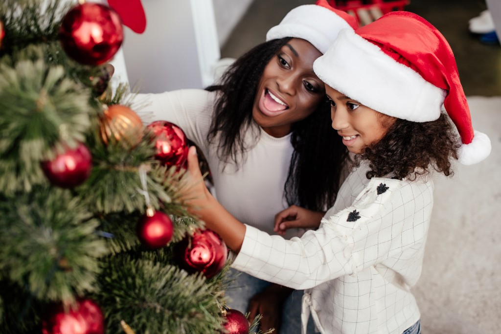 Girls Decorating A Christmas Tree